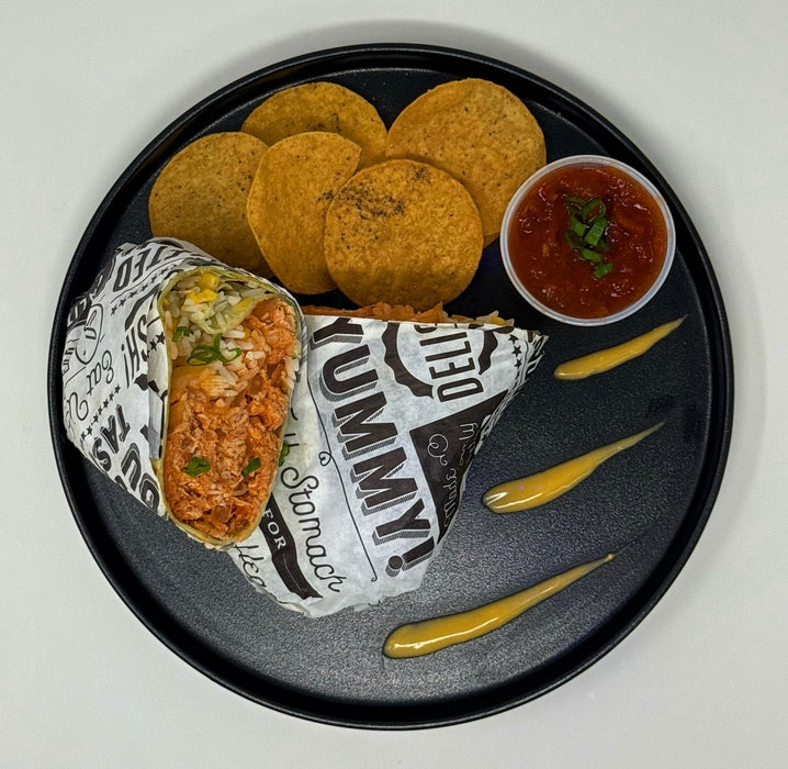 Burrito, tortilla chips, and salsa on a black plate with 'Delish' and 'Yummy' text.