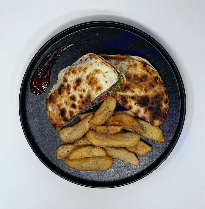 Plated dish with grilled bread and potato wedges on a white background