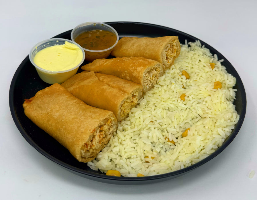 Platter with rice, spring rolls, and two small bowls of dipping sauces on a white background