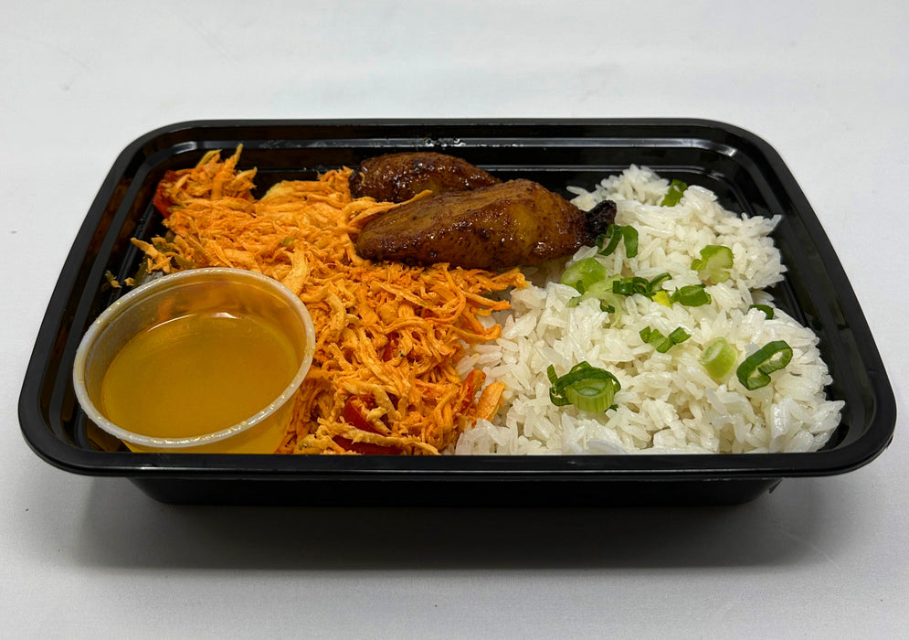 Plate of food with rice, black dish, and green vegetables on a white background