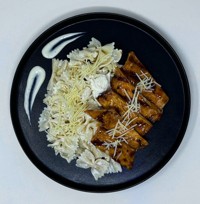 Grilled chicken breast mixed with bow tie pasta, mozzarella balls topped with our low fat Alfredo sauce - West Orange NJ Meal Preps