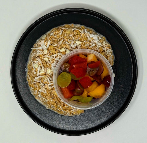 Oatmeal with fruit on a black plate