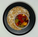Oatmeal with fruit on a black plate