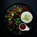 Plated dish with rice, meat, and vegetables on a dark background