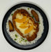 Plated dish with fried chicken, rice, and vegetables on a white background