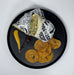 Wrap with tortilla chips and condiments on a black plate