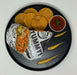 Burrito, tortilla chips, and salsa on a black plate with 'Delish' and 'Yummy' text.