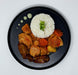 Plated dish with rice, chicken, carrots, and vegetables on a white background
