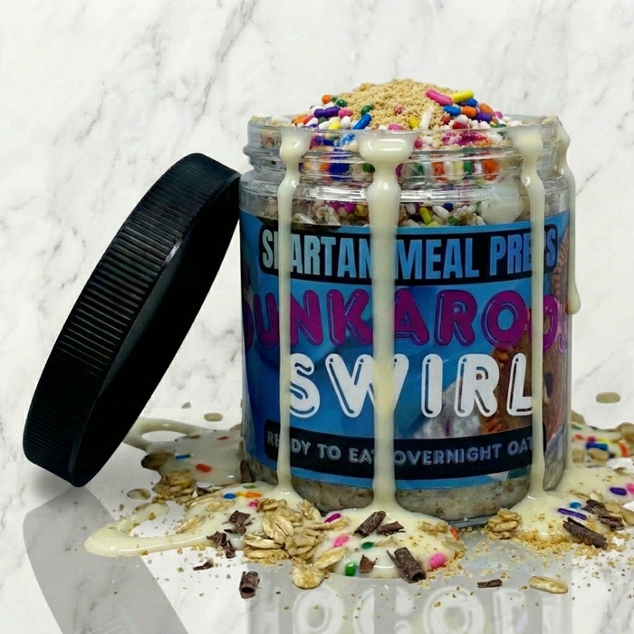 Jar of 'Punkaro's Swirl' overnight oats with colorful sprinkles on a marble surface.