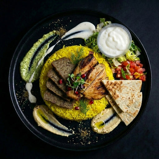 Plated dish with yellow rice, grilled meats, and vegetables on a dark background.