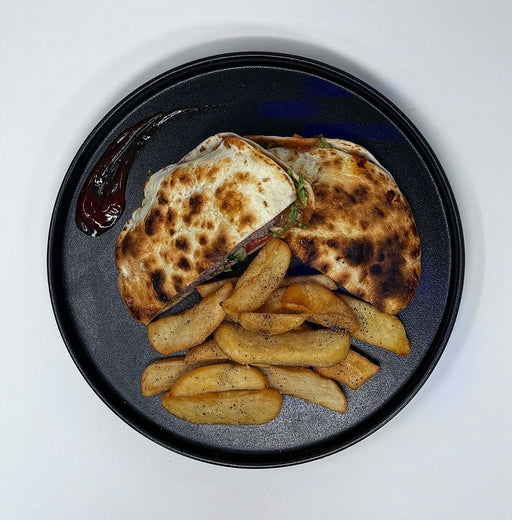 Plated dish with grilled bread and potato wedges on a white background