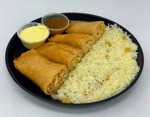 Platter with rice, spring rolls, and two small bowls of dipping sauces on a white background
