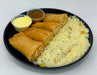 Platter with rice, spring rolls, and two small bowls of dipping sauces on a white background