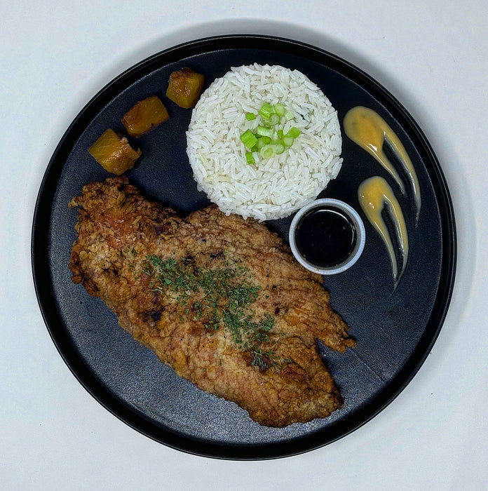 Plated dish with fried chicken, rice, and vegetables on a black plate. Healthy meal made by spartan mela preps nj.