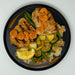 Plated dish with grilled bread, vegetables, and sliced carrots on a white background
