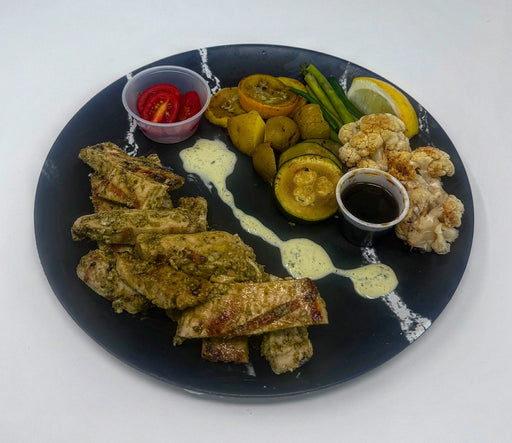 Plated dish with fried spring rolls, vegetables, and sauces on a white background