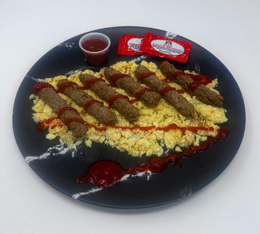 Plate with scrambled eggs, sausages, and ketchup on a white background made by spartan meal preps a new jersey meal prep company
