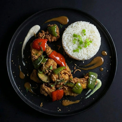 Plated dish with rice, vegetables, and meat on a dark background