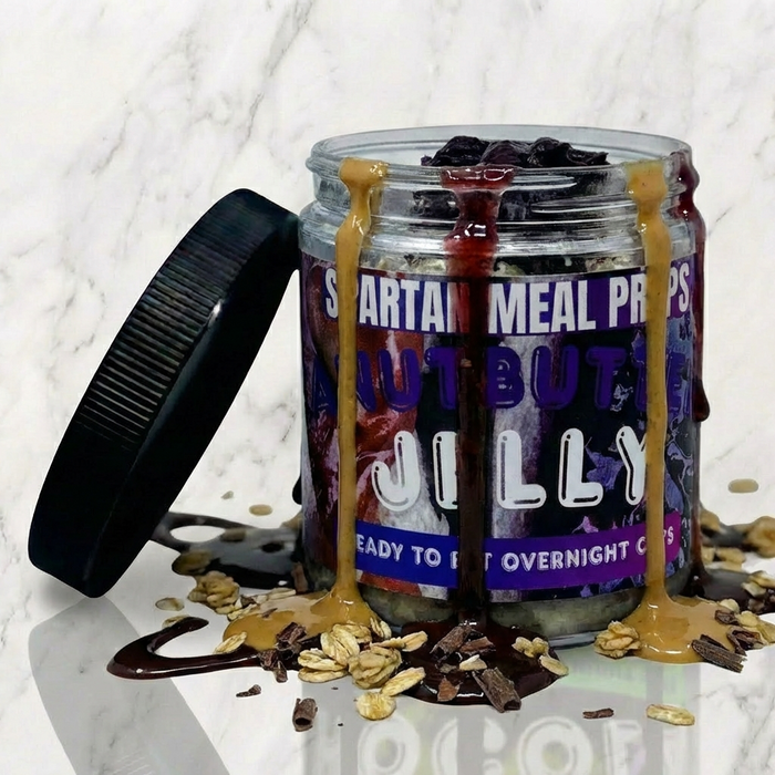 Jar of 'Jilly' Spartan Meal Protein with a black lid on a marble surface