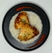 Plated dish with rice, fried chicken, and red sauce on a white background