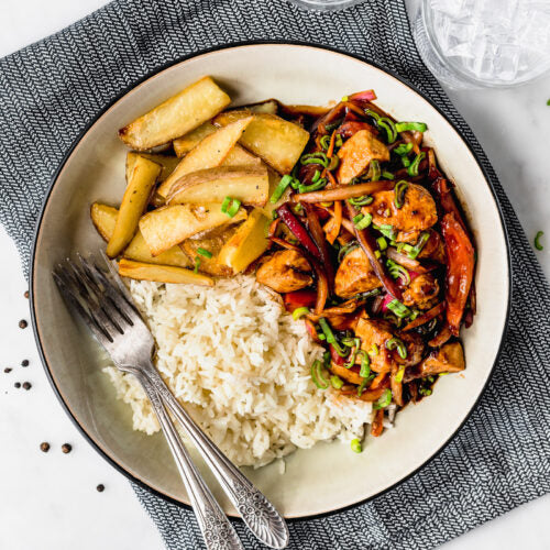 Peruvian-chicken-stir-fry-spartan - meal-preps- chicken with rice and steak fries on a white plate. 