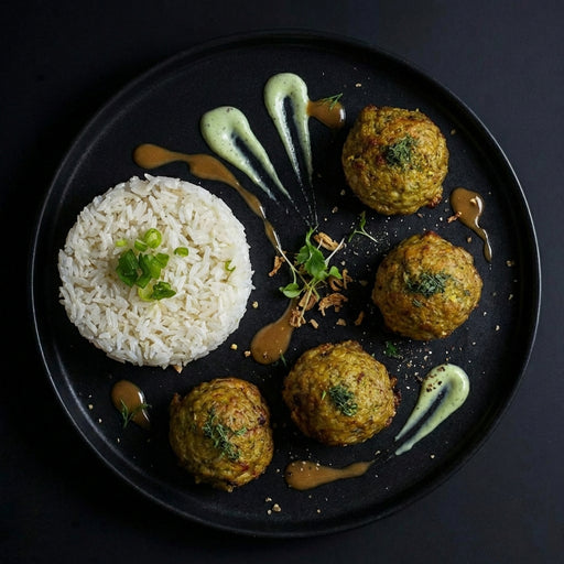Plated dish with rice, falafel balls, and sauces on a dark background