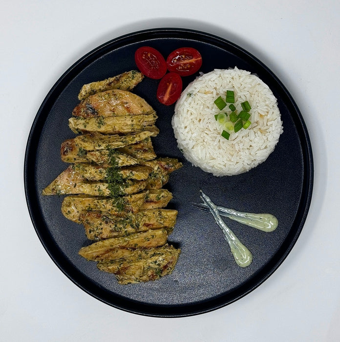 Plated dish with fried green vegetable sticks and white rice on a black plate.