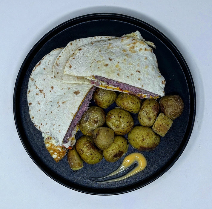Quesadillas with potato salad on a black plate