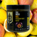 Sea moss gel container labeled 'Passion Fruit Blast' surrounded by passion fruits and lemons.