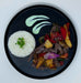 Plated dish with rice, steak, vegetables, and plantains on a black plate. Healthy meal made by spartan meal preps new jersey.