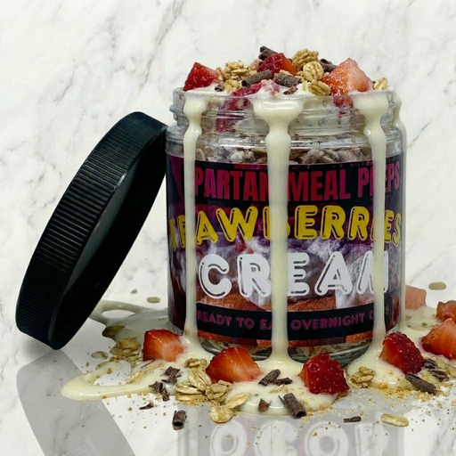 Meal replacement shake with strawberries and cream flavor on a marble surface - meal made by spartan meal preps nj