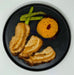 Plated dish with roasted meat, mashed potato, and asparagus on a black plate.