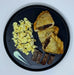 Plate of food with three empanadas, eggs, and on a dark plate. pieces of turkey sausage on a black plate. Healthy meal made by spartan mela preps new jersey.