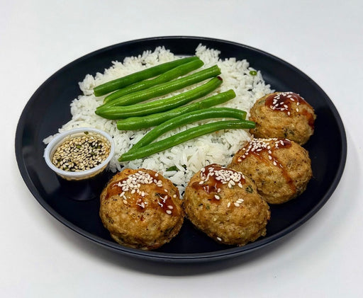 Korean sesame chicken meatballs - Spartan Mela preps NJ - 4 meatballs on a plate with rice and green beans - spartan meal preps healthy meal.