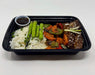 A plate of Korean Teriyaki steak bowl with jasmine rice, mixed vegetables, and steak, served with a side sauce on a black plate meal made by spartan meal preps nj.