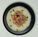 Plated dish of rice with chicken and green onions on a white background
