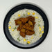 Plated dish of rice with chicken and pineapple pieces on a white background