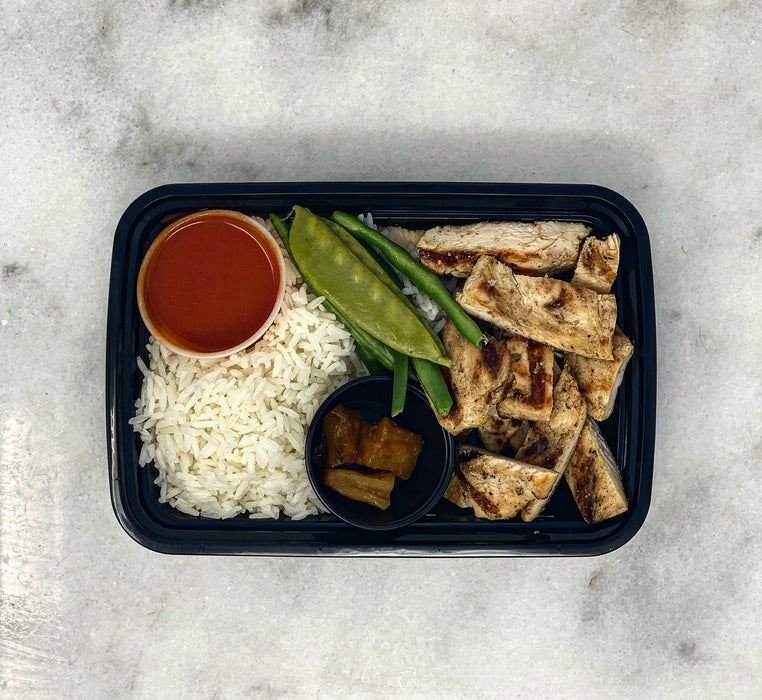 Buffalo grilled chicken breast paired with jasmine rice, green beans and side cup of grilled pineapples - spartan meal preps