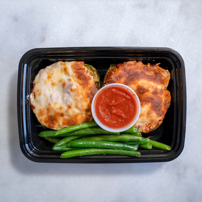 Puerto Rican style grass-fed ground beef stuffed inside a green bell pepper with brown rice, onions, three cheese melted over the surface with a side of veggies - Toms River NJ Meal Preps