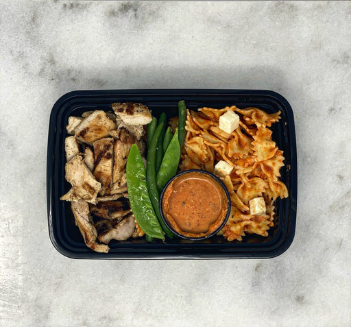 Grilled chicken breast paired with whole wheat bowtie pasta tossed in vodka cause paired with cauliflower florets- ny meal prep delivery service
