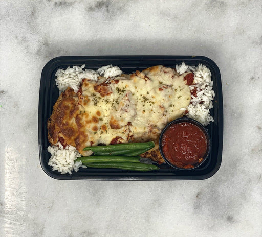 A healthy chicken parm fried in coconut oil paired with jasmine rice and green beans - spartan meal preps ny meal delivery service